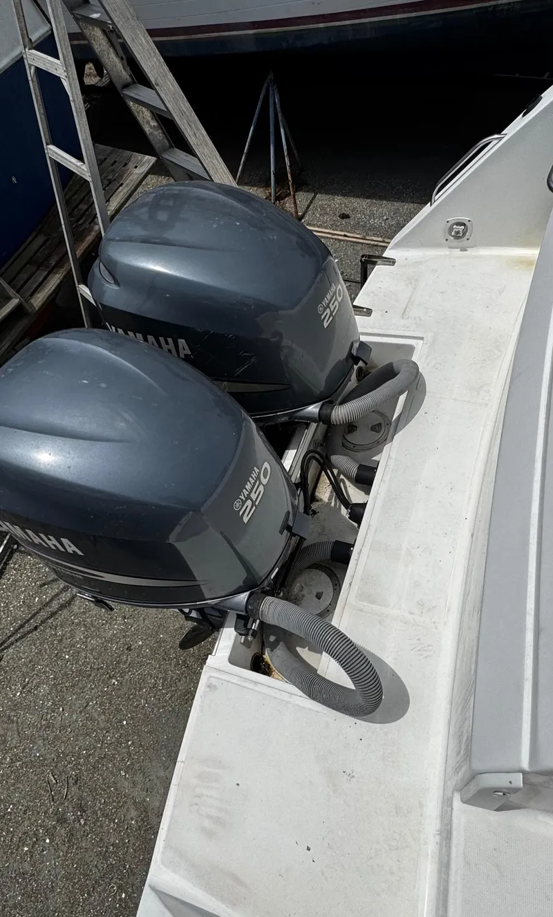 Slide: The Image of 2001 Stamas 310 Express with twin Yamaha 250 outboard engines, docked. - 17