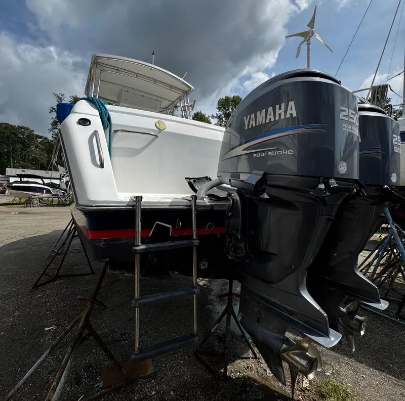 Slide: The Image of 2001 Stamas 310 Express boat with Yamaha outboard motors on a trailer. - 8