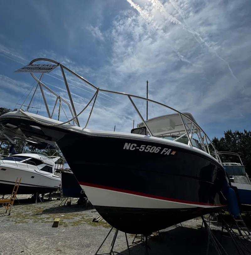 Slide: The Image of 2001 Stamas 310 Express boat on dry dock under a clear sky. - 9