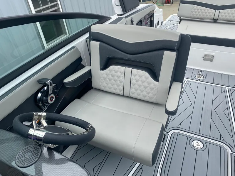 Slide: The Image of 2025 Monterey 258 Super Sport boat interior with sleek steering and modern seating design. - 26