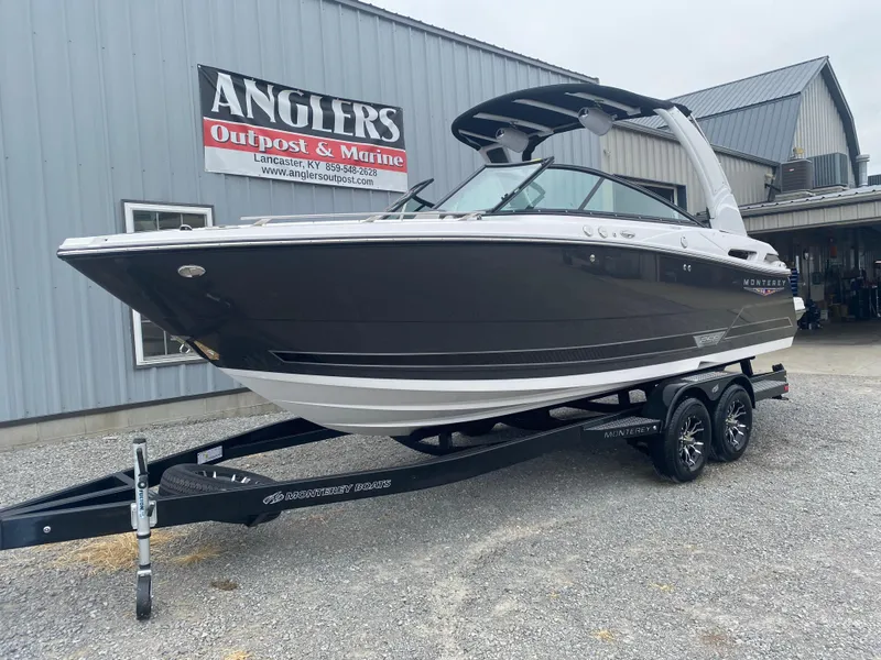 Slide: The Image of 2025 Monterey 258 Super Sport boat on trailer outside Anglers Outpost & Marine building. - 3
