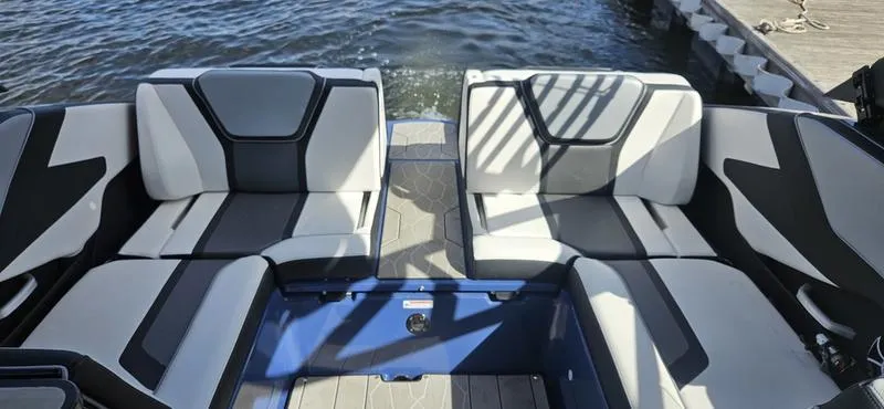 Slide: The Image of 2023 Yamaha Boats 255XD interior seating with modern design on the water. - 4