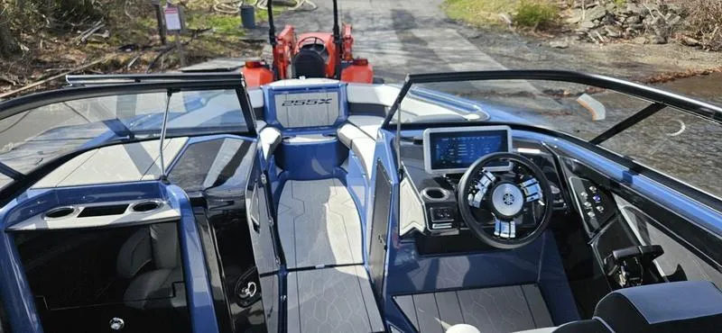 Slide: The Image of 2023 Yamaha Boats 255XD interior with modern dashboard and steering wheel. - 8