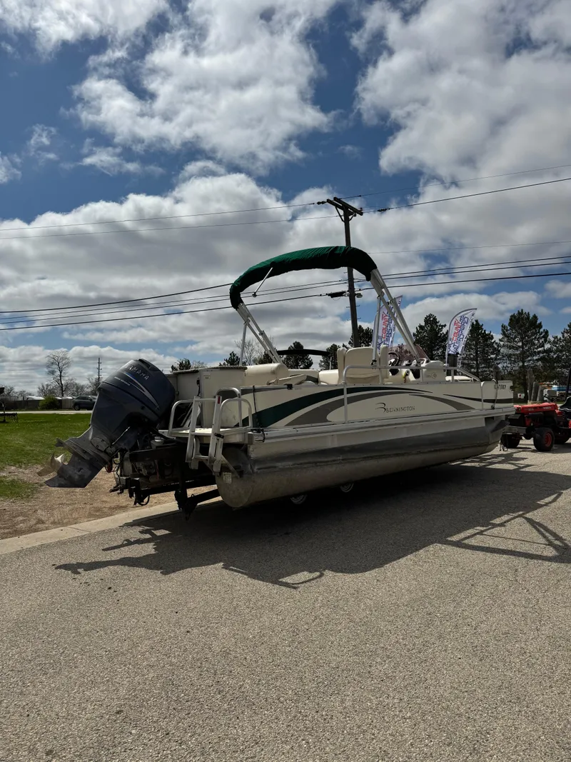 Slide: The Image of 2007 Bennington 2050 FSI pontoon boat on trailer under cloudy sky. - 1