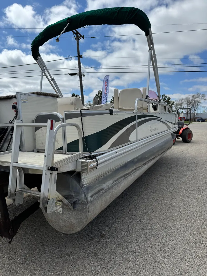 Slide: The Image of 2007 Bennington 2050 FSI pontoon boat with canopy, parked on a trailer. - 10