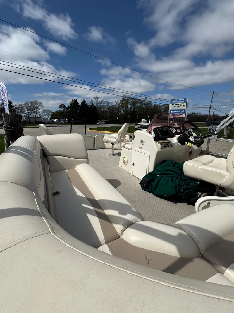 Slide: The Image of 2007 Bennington 2050 FSI pontoon boat with beige seating under a blue sky. - 14