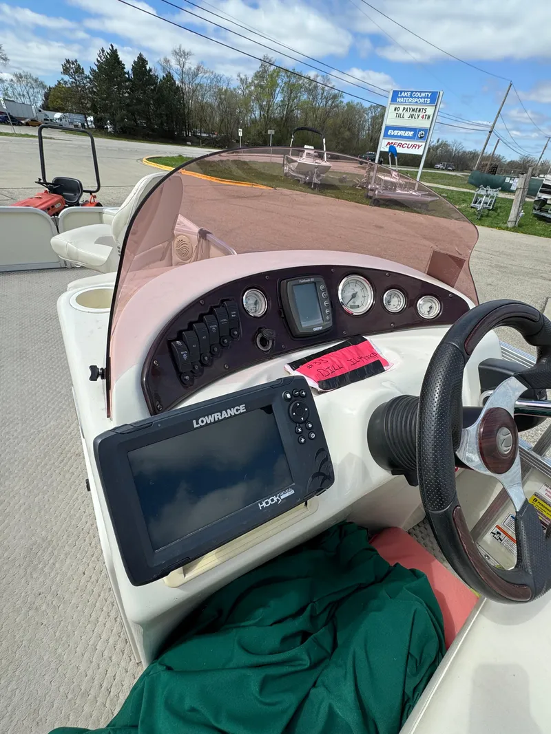 Slide: The Image of 2007 Bennington 2050 FSI boat dashboard with Lowrance fishfinder and steering wheel. - 16