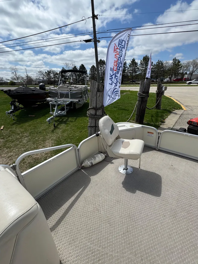 Slide: The Image of 2007 Bennington 2050 FSI boat with seating, displayed outdoors under a partly cloudy sky. - 19