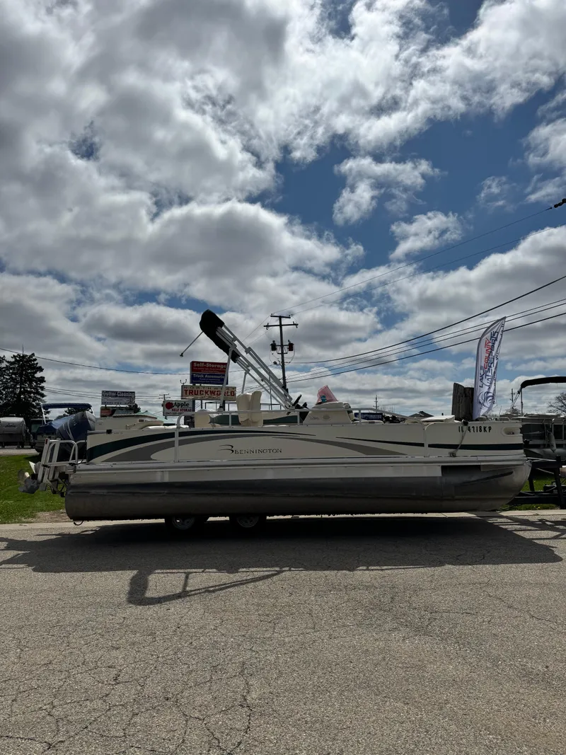 Slide: The Image of 2007 Bennington 2050 FSI pontoon boat under cloudy sky at dealership. - 2