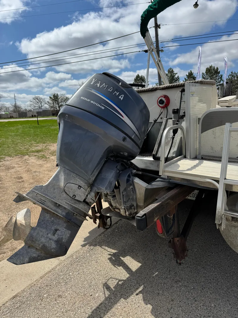Slide: The Image of 2007 Bennington 2050 FSI boat with Yamaha outboard motor on a trailer. - 31