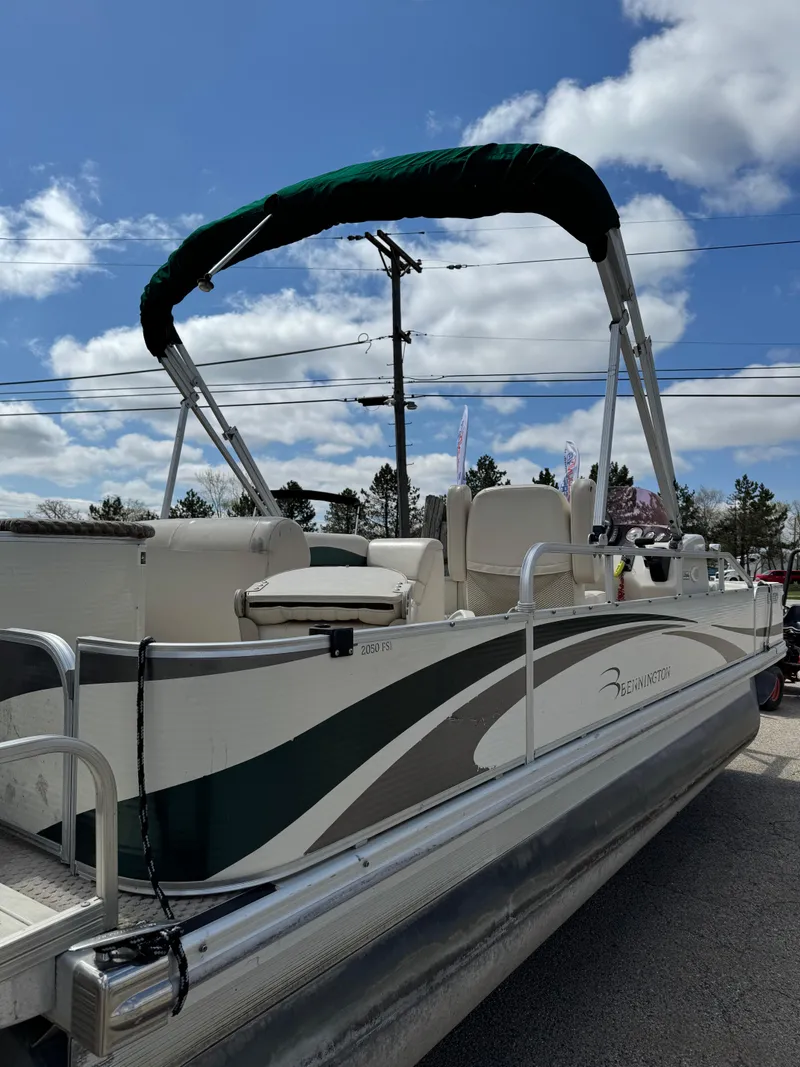 Slide: The Image of 2007 Bennington 2050 FSI pontoon boat with canopy, parked outdoors under a blue sky. - 33