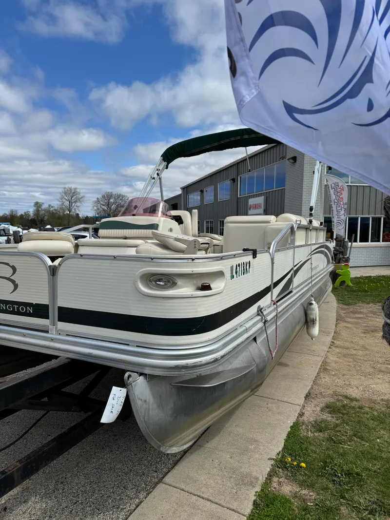 Slide: The Image of 2007 Bennington 2050 FSI pontoon boat displayed outdoors on a trailer. - 6