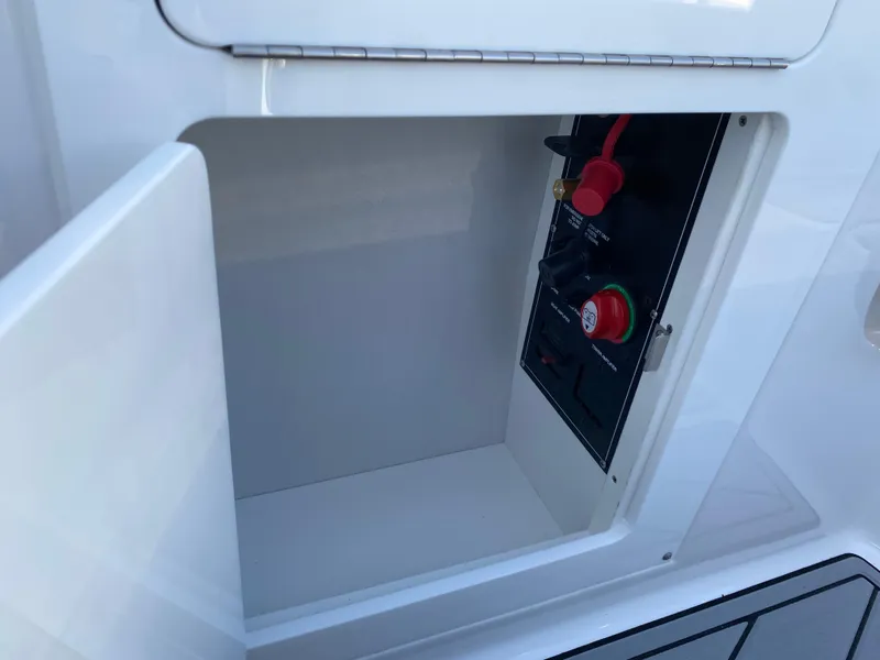 Slide: The Image of Open compartment on 2025 Monterey M6 boat showing control panel. - 10