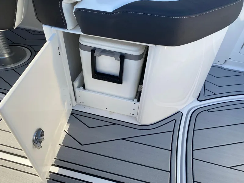 Slide: The Image of 2025 Monterey M6 boat interior with open storage compartment and cooler on stylish deck. - 12