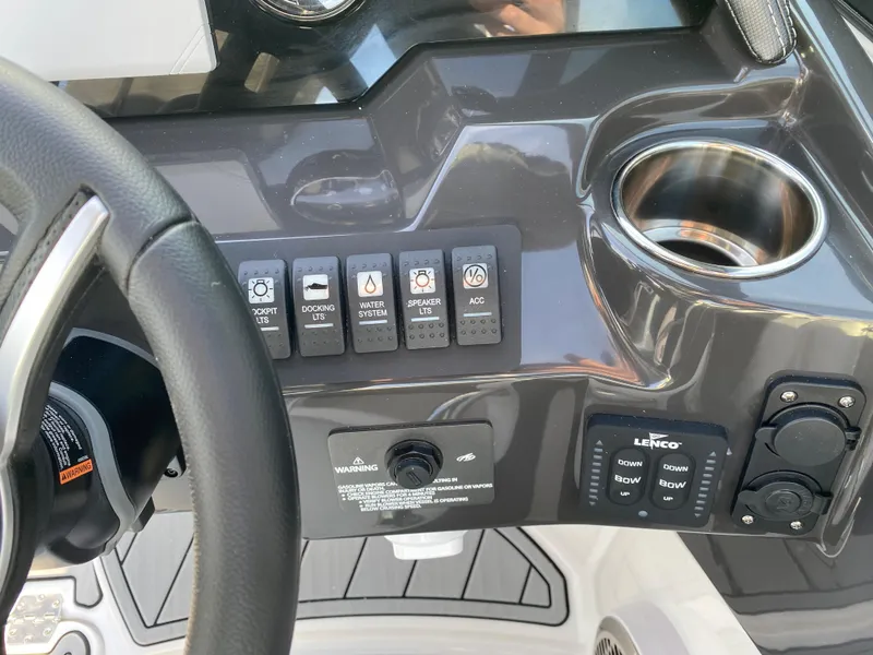 Slide: The Image of Control panel of 2025 Monterey M6 boat with switches and cup holder. - 18