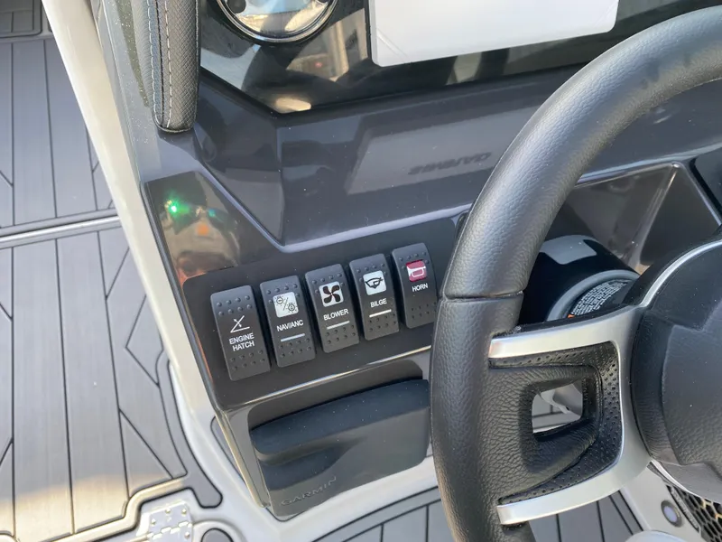 Slide: The Image of 2025 Monterey M6 boat dashboard with control switches and steering wheel. - 19