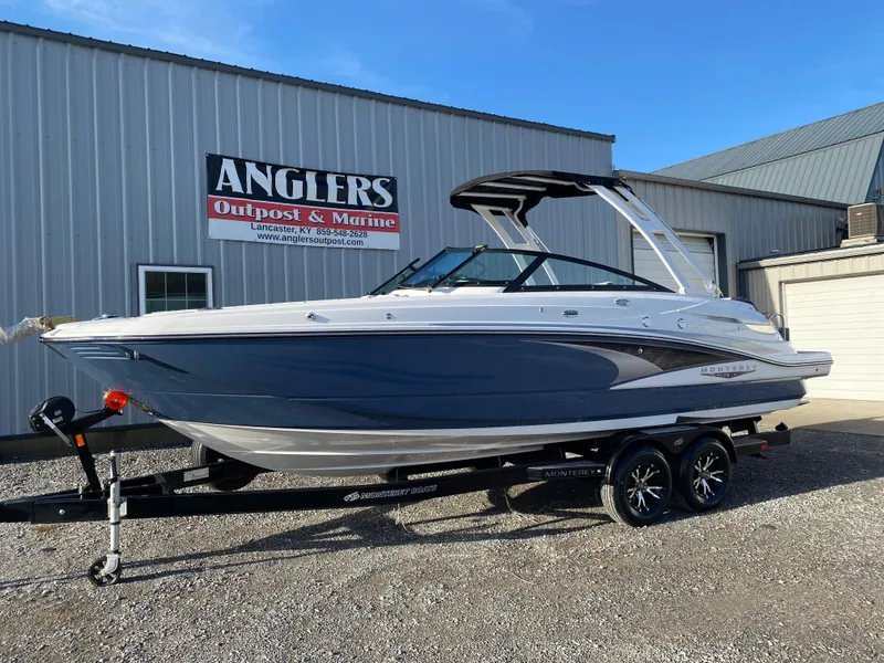 Slide: The Image of 2025 Monterey M6 boat on trailer outside Anglers Outpost & Marine building. - 2