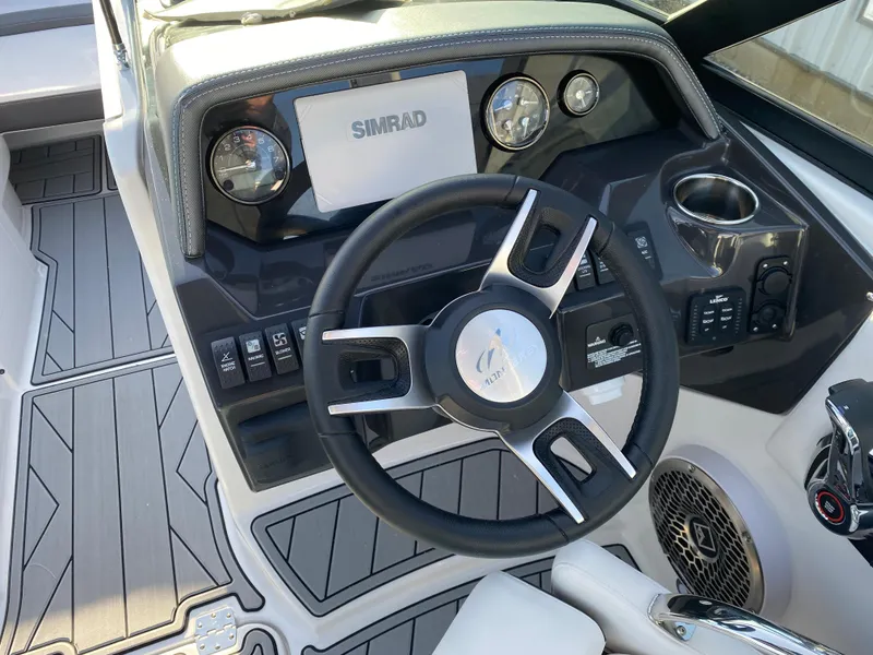Slide: The Image of 2025 Monterey M6 boat dashboard with steering wheel and Simrad display. - 20