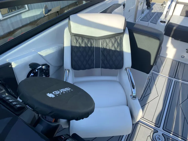 Slide: The Image of Captain's seat on 2025 Monterey M6 boat with sleek design and modern controls. - 21