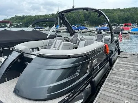 The Image of 2022 Bennington QX 23 Quad Bench pontoon boat docked at a marina. - 1
