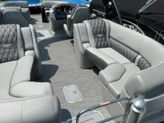 Slide: The Image of 2022 Bennington QX 23 Quad Bench interior with luxurious gray seating and modern design. - 6