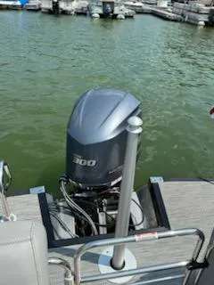 Slide: The Image of 2022 Bennington QX 23 Quad Bench boat with powerful 300 HP engine on a calm lake. - 8