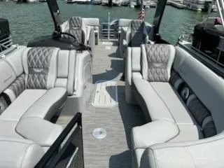 Slide: The Image of 2022 Bennington QX 23 Quad Bench boat interior with luxurious seating and elegant design. - 9
