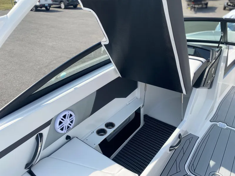 Slide: The Image of 2025 Monterey M-22 boat interior with storage compartment and cup holders. - 12
