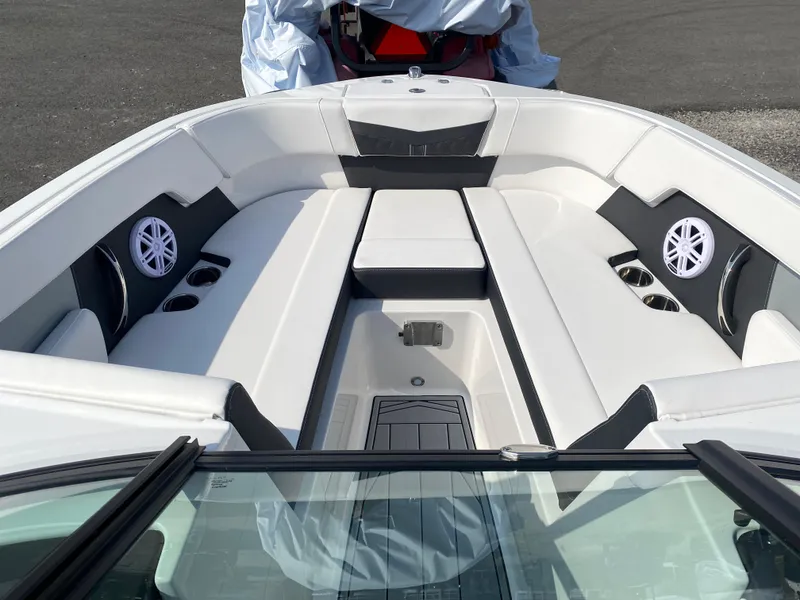 Slide: The Image of 2025 Monterey M-22 boat interior with white seating and built-in speakers. - 13