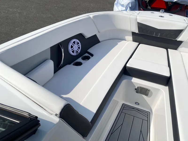 Slide: The Image of 2025 Monterey M-22 boat interior with white seating, cup holders, and speaker. - 14