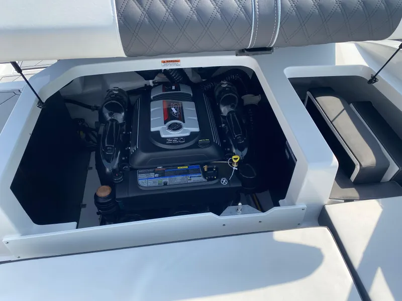 Slide: The Image of 2025 Monterey M-22 boat engine compartment with cushioned seating and modern design. - 21