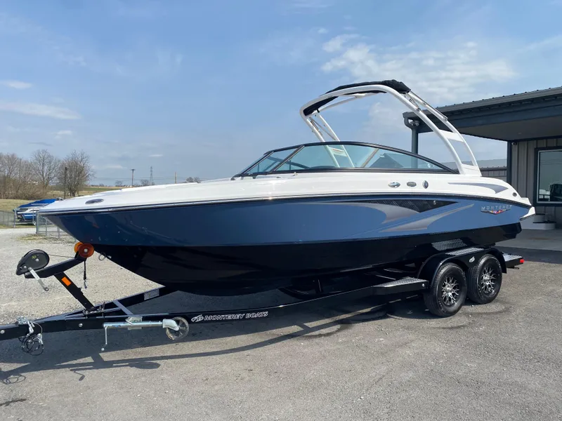 Slide: The Image of 2025 Monterey M-22 boat on trailer, sleek design, blue and white exterior, parked outdoors. - 3