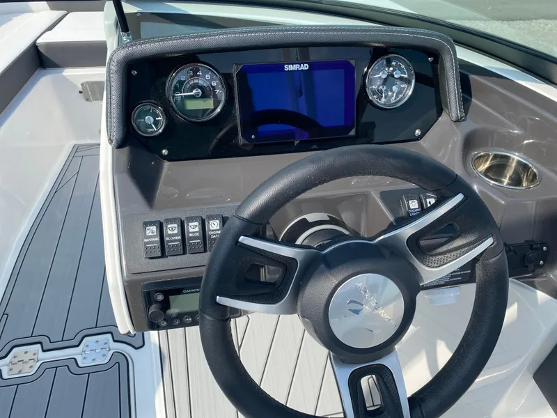 Slide: The Image of Steering wheel and dashboard of 2025 Monterey M-22 boat with modern controls and display. - 9