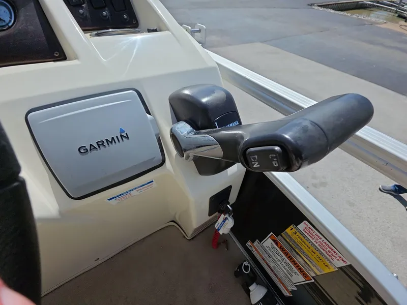Slide: The Image of Control panel of 2013 Bennington 24 SSLX boat with Garmin device and throttle lever. - 10