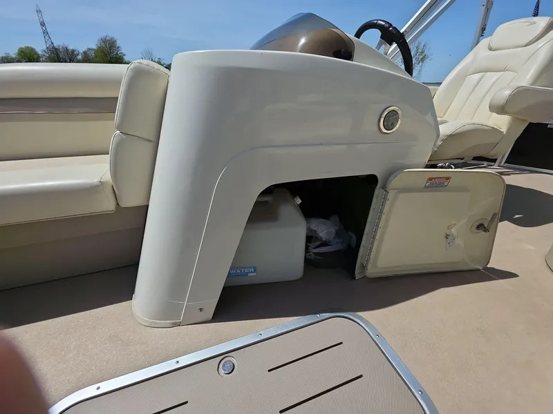 Slide: The Image of 2013 Bennington 24 SSLX boat interior with open storage compartment and seating. - 11