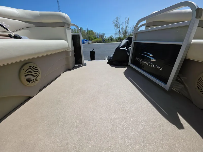 Slide: The Image of Interior view of a 2013 Bennington 24 SSLX pontoon boat with beige seating. - 12