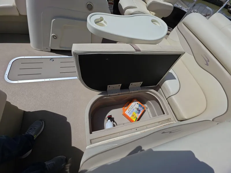 Slide: The Image of 2013 Bennington 24 SSLX boat interior with open storage compartment and seating. - 17