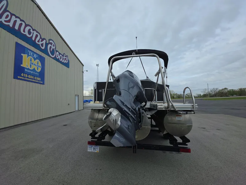 Slide: The Image of 2013 Bennington 24 SSLX pontoon boat with outboard motor at dealership. - 3