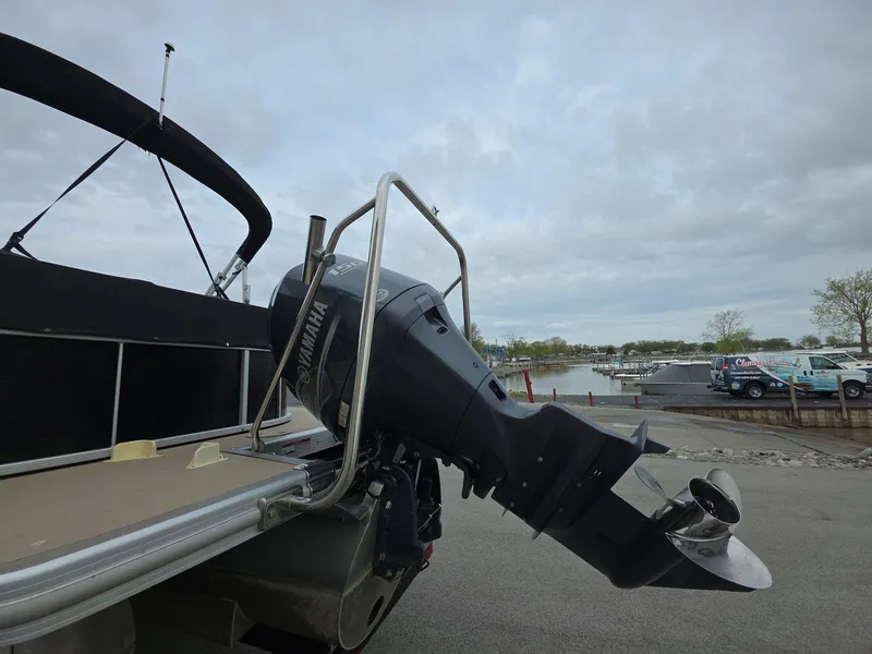Slide: The Image of 2013 Bennington 24 SSLX pontoon boat with Yamaha outboard motor at a marina. - 4