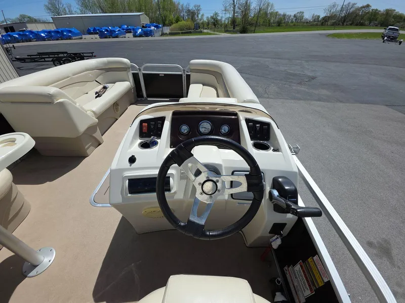 Slide: The Image of 2013 Bennington 24 SSLX boat interior with steering wheel and seating area. - 9