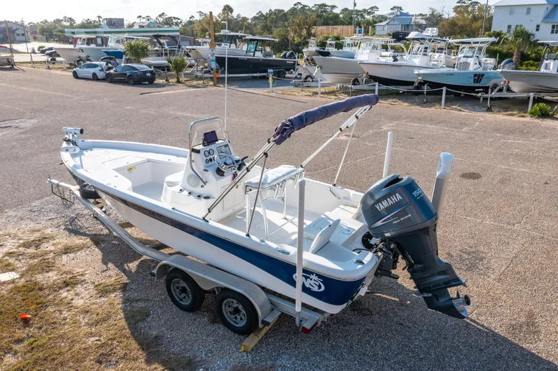Slide: The Image of 2011 NauticStar 2110 Nautic Bay boat on trailer with Yamaha outboard motor in marina setting. - 22