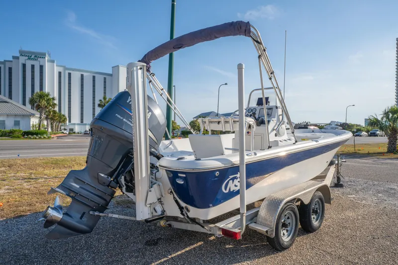 Slide: The Image of 2011 NauticStar 2110 Nautic Bay boat on trailer, parked outdoors near buildings. - 4