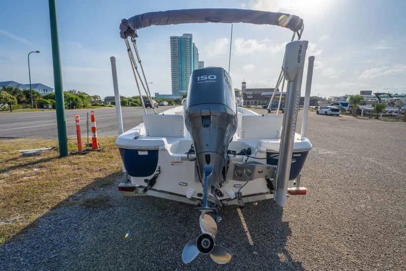 Slide: The Image of 2011 NauticStar 2110 Nautic Bay boat with Yamaha 150 engine, parked on gravel lot. - 5