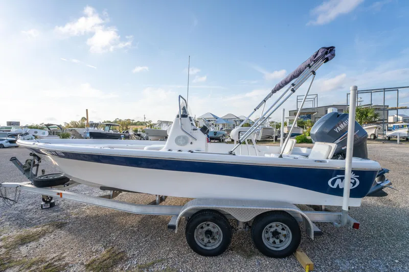Slide: The Image of 2011 NauticStar 2110 Nautic Bay boat on trailer, parked outdoors under a clear sky. - 7