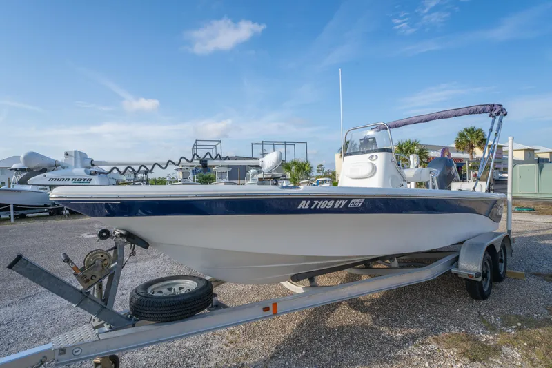 Slide: The Image of 2011 NauticStar 2110 Nautic Bay boat on trailer, parked outdoors under clear sky. - 8