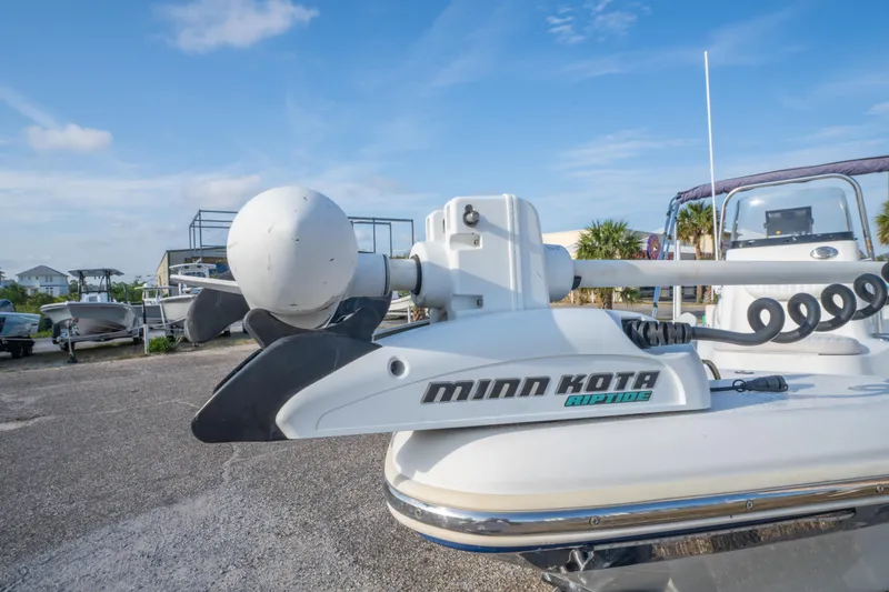Slide: The Image of 2011 NauticStar 2110 Nautic Bay boat with Minn Kota trolling motor, parked outdoors. - 9