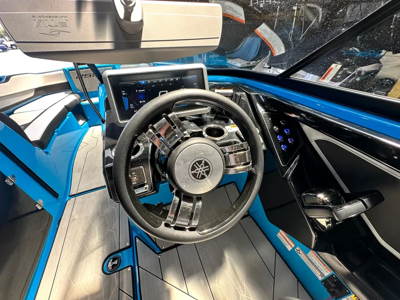 Slide: The Image of 2023 Yamaha Boats 255XD cockpit with modern steering wheel and digital display. - 10