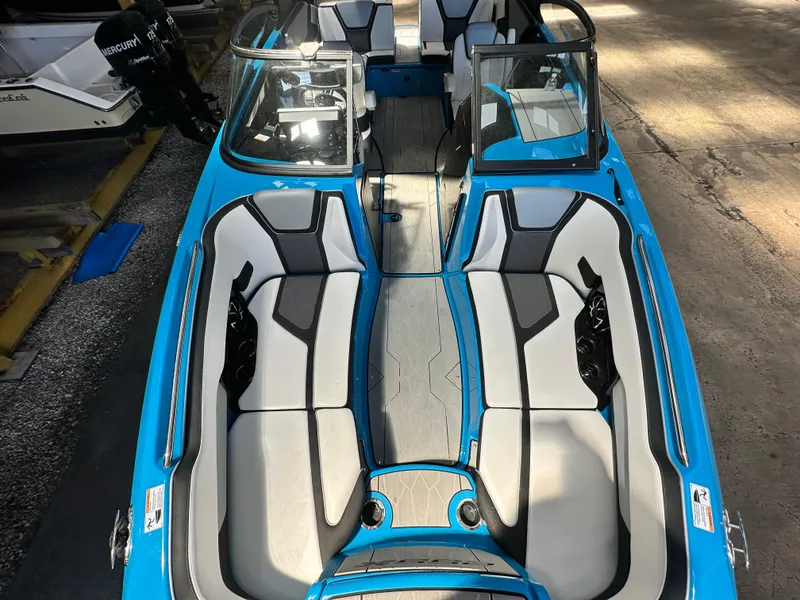 Slide: The Image of 2023 Yamaha Boats 255XD with blue exterior and spacious seating. - 14