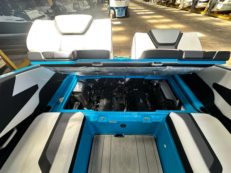 Slide: The Image of 2023 Yamaha Boats 255XD interior with open engine compartment, showcasing modern design and seating. - 19
