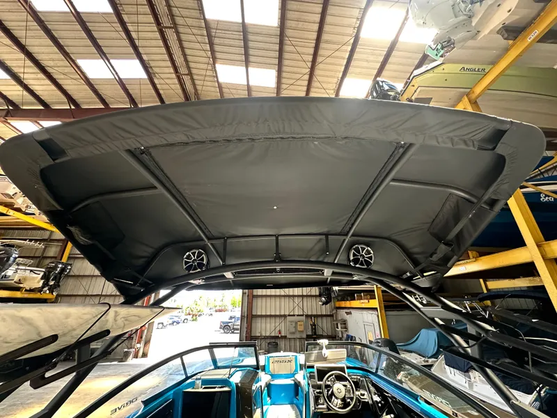 Slide: The Image of 2023 Yamaha Boats 255XD with a sleek canopy and modern interior design. - 7